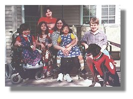 Photo: service dog Magic, the five children he works with and their mother - End of Photo Description