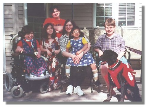 Photo of Service Dog Magic with the with the 5 children he assists and their mother